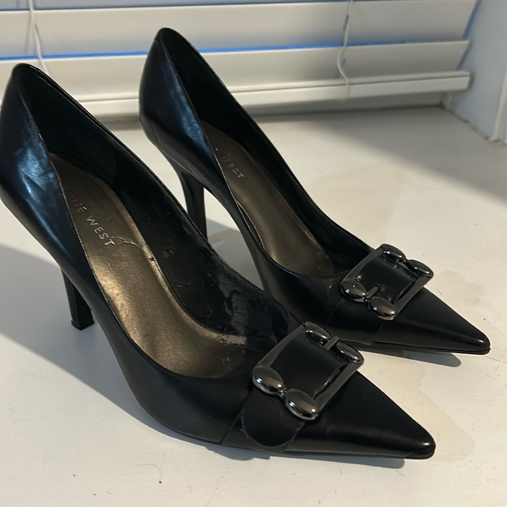 Nine West leather pumps with front buckle detail.